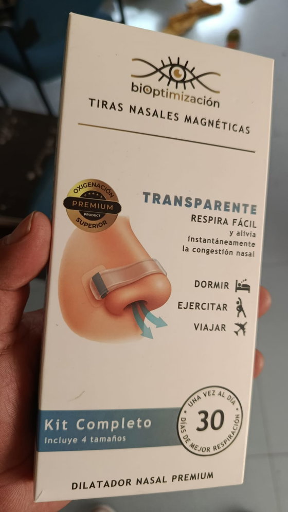 Mano sosteniendo la caja del kit del dilatador nasal magnético