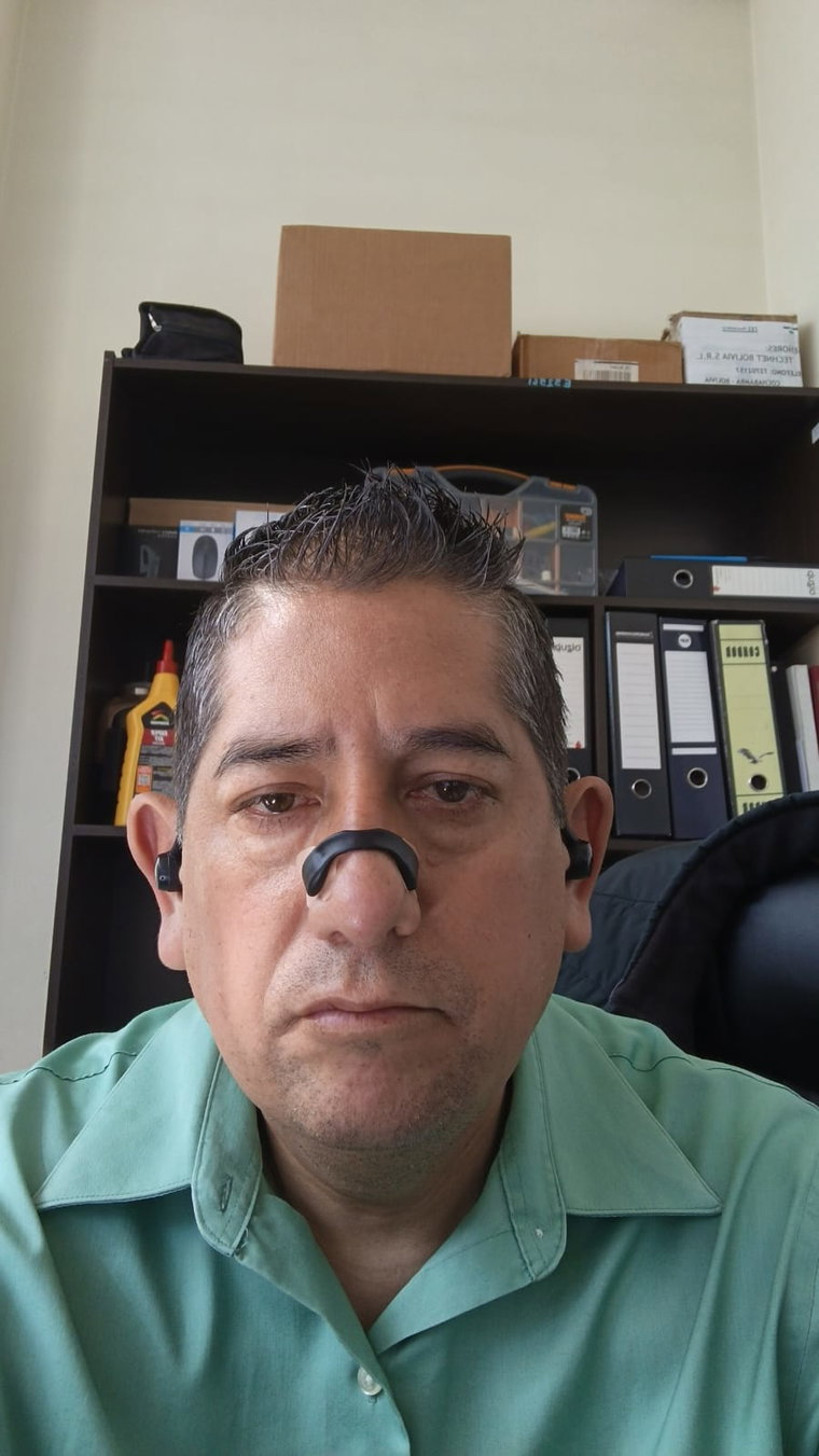 Cliente en su escritorio de trabajo con la tira nasal negra puesta durante el día
